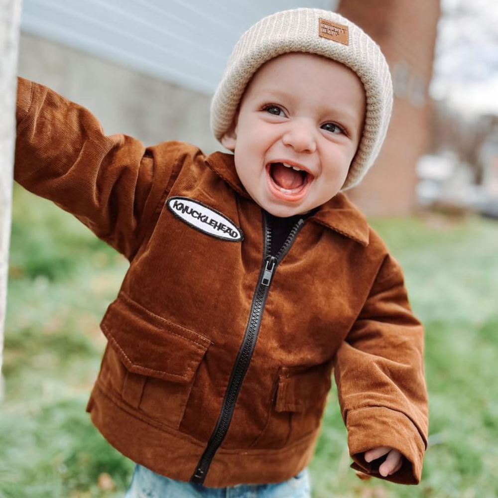 baby wearing off white beanie