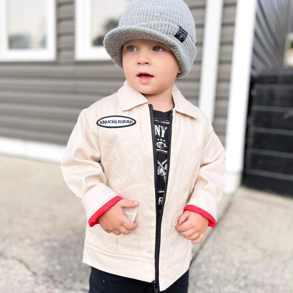 Tan Knuckleheads Mechanic Jacket with long sleeves, featuring the Knuckleheads logo. Perfect for keeping your little one warm and stylish. Available in sizes S to XXL for kids aged 6 months to 8 years.