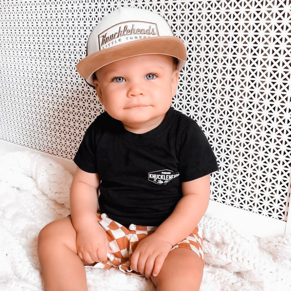 A photo showcasing a variety of vibrant kids trucker hats with playful designs, perfect for your child's outdoor adventures. These hats feature a mesh back for breathability and a classic trucker hat design, made for kids ages 2-7. Choose from a range of colors and designs to find the perfect hat for your little one.