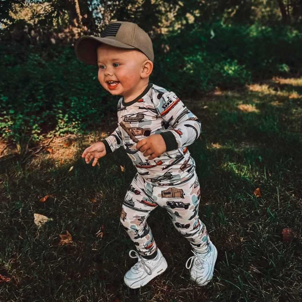 Image of Khaki Kids Trucker Hat with USA Flag Patch: A patriotic and stylish accessory designed for kids. In a versatile khaki shade, it features a prominent USA flag patch on the front. Elevate your child's style with this fashionable hat, perfect for adding a touch of national pride to their outfits.