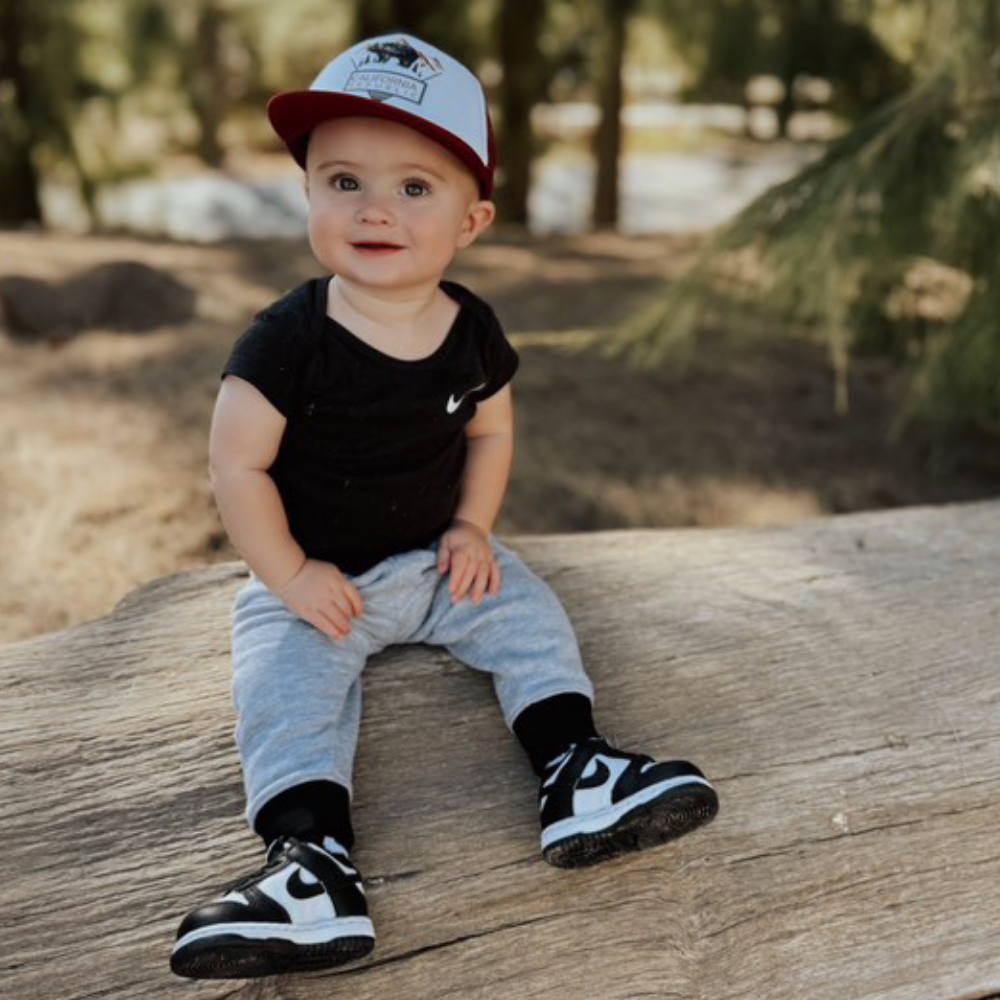 Image of Burgundy Kids Trucker Hat with California Republic Patch: A sophisticated and stylish accessory designed for kids. In rich burgundy, it showcases a captivating California Republic patch on the front. Elevate your child's style with this fashionable hat, perfect for expressing their allegiance to the Golden State.