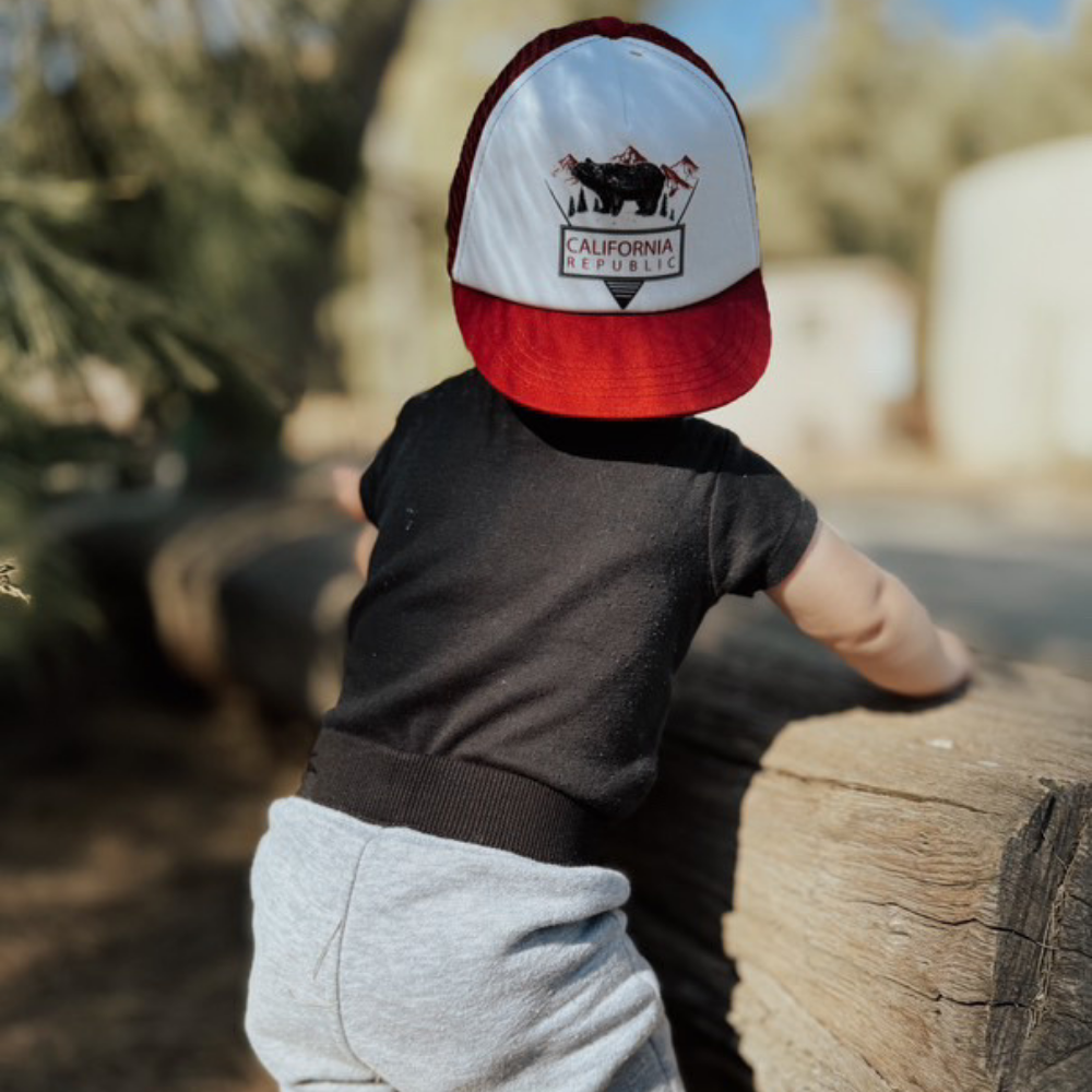 Image of Burgundy Kids Trucker Hat with California Republic Patch: A sophisticated and stylish accessory designed for kids. In rich burgundy, it showcases a captivating California Republic patch on the front. Elevate your child's style with this fashionable hat, perfect for expressing their allegiance to the Golden State.