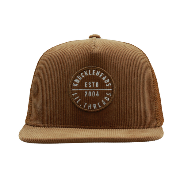 Image showcasing a Corduroy Brown Kids Trucker Hat with a classic Knuckleheads patch. Designed for children, this hat combines the timeless appeal of corduroy with the iconic Knuckleheads patch. A standout accessory in our collection, it adds a touch of style and personality to your little one's look.