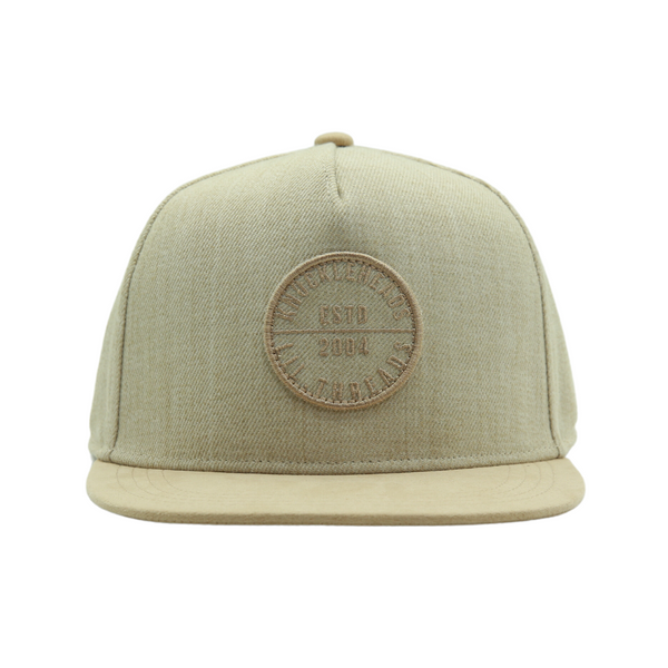 Introducing an Oat Kids Trucker Hat adorned with a classic Knuckleheads patch. This hat is designed for children, featuring a warm and inviting oat color complemented by the iconic Knuckleheads patch. A standout accessory in our collection, it adds a touch of style and personality to your little one's look.