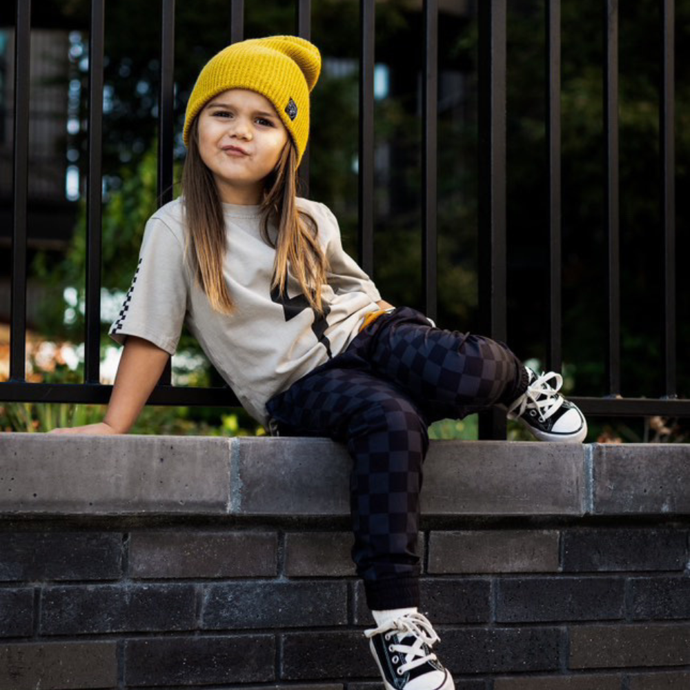 Image highlighting a vibrant yellow beanie from Knuckleheads, designed for children. This versatile beanie, complete with the Knuckleheads brand tag, offers a classic style suitable for infants and toddlers. A cheerful addition to the collection of Infant hats, adding a bright touch of charm.